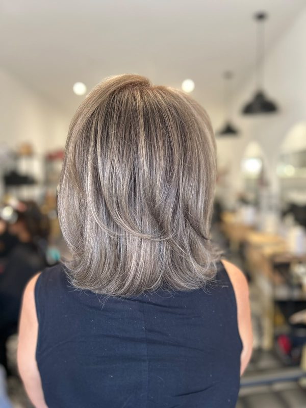 Shoulder-length layered cut in soft ash tones, by Lauren